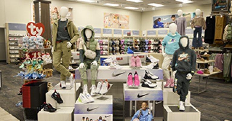 A big display featuring some mannequins and kids' athletic shoes